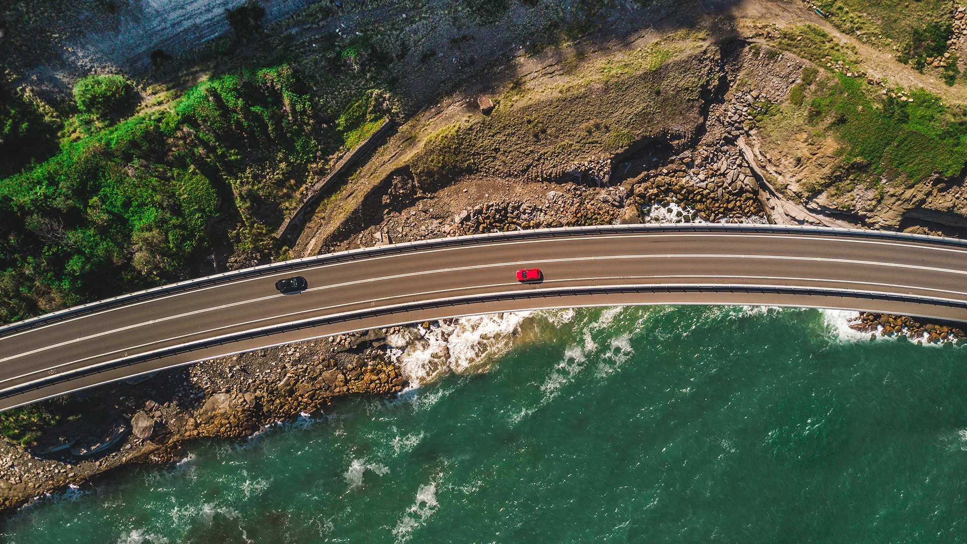 cars driving along a coast road